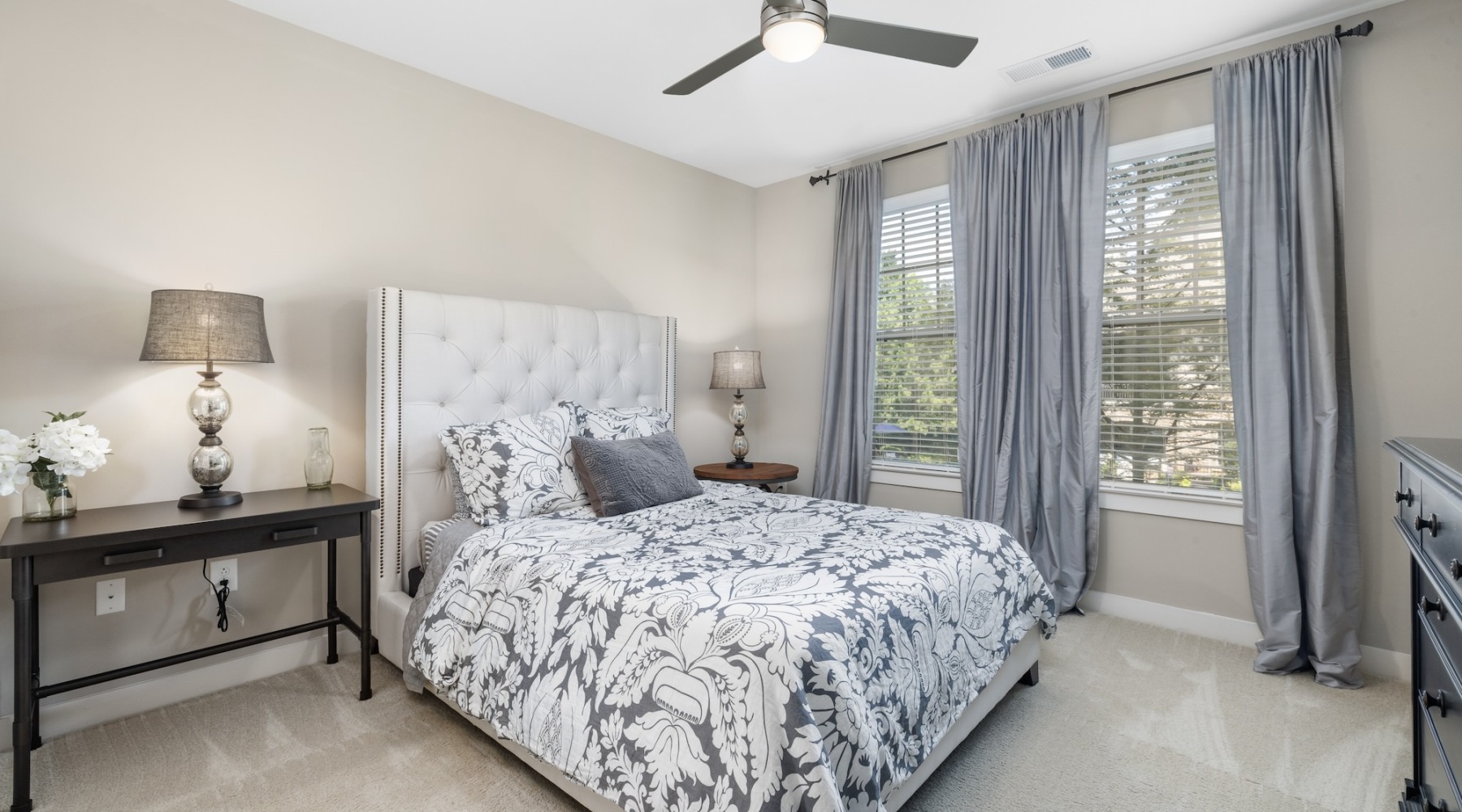 Sleep in style bedroom with large windows and nightstand